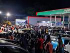 People gathering at a gas station during a typical fuel shortage