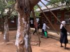 Students arrive an hour early to mop the classrooms, sidewalks, and clean the courtyard. Notice how the chalk residue on the trees from erasers
