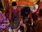 The bride and groom receiving henna for luck and protection