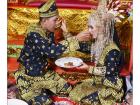 The bride and groom feeding each other during makan beradab