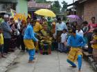 Two boys perform silat in front of the groom as a sign of honor