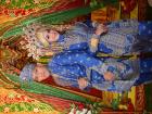 The bride and groom in their elegant blue attire, a symbol of tradition and unity