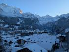 Here are some Alpine houses (chalets) covered in a thick blanket of winter snow.