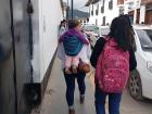 A Peruvian mother carrying her baby on her back, a common sight here