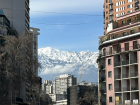 The snowy Andes mountains seen from the middle of the city