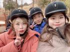Aisa at a horse ranch with her mother and father