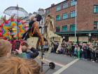 A man riding a big mechanical horse that he is controlling