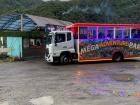 To visit the waterfalls of Baños, you can get on a bus with colorful lights and lots of music called a "chiva"