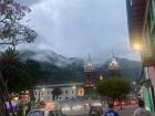 The central park in Baños looks so lovely on this foggy evening!