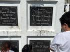 A family lays flowers at the grave of their loved one