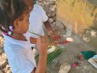 Some first graders pretending to make spaghetti together
