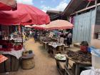 Markets are filled with tables and cloth on the ground full of produce, dried fish, and other goods