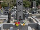 My family gravestone, decorated with flowers and some food offerings