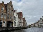 There are rows of houses all along the canal