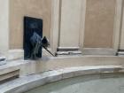 A pigeon lazing on top of a fountain decorated by unicorns 
