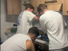 Our friends hard at work for dinner, roasting vegetables and stirring risotto
