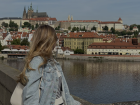On the famous Charles Bridge with the view of Prague in the background 