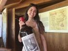 Me holding a big bottle of wine that comes from the grapes of the vineyards!