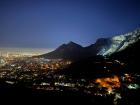 Cape Town at night, with Table Mountain illuminated to the right 