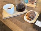 A drip coffee and pastry while doing work with a friend