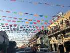 A picture of papel picado, which is the paper decorations going across the buildings in Tlaquepaque