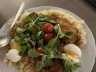 Home cooked meal: Tomato Chicken stew with some salad, tomatoes and eggs
