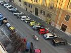 Overhead view of parked cars and scooters; Rome’s tight spaces make small vehicles the best option for daily travel