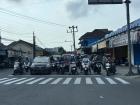 Ojek and cars stopped at a busy street light