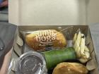 A snack box with tofu, chicken, rice and pudding