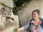 Me getting water out of a cool water fountain in Mulbach, Italy