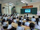 Students in Vietnam wearing uniforms and learning together in their classroom