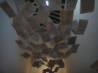 An art installation of pages on the ceiling