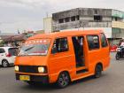 An orange angkot at the local market