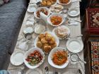 This is a pre-meal dastorkon from a village called Krasnorechenka. In addition to the boorsok, salad, and bread found on the table, we also had tea, honey, soup, and a main course