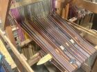 Up close photo of the traditional loom used to weave together fabric