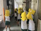 Students wear these protective head coverings during earthquake drills!