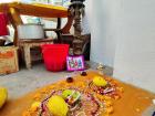 A mandala and diyas (oil lamps) in the background 