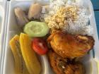 A lunch of chicken, rice, and boiled bananas