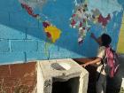 A student checking out the world map at school. He was surprised at how small Belize is!