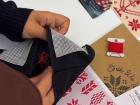 You will need to use waste canvas to stitch onto soft items like this black pouch (photo captured by tatreez instructor)