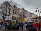 Tractors and trucks carrying local marching bands who are performing at the Cologne carnival parade