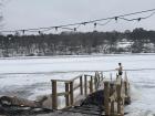 Frozen lake plunge near an outdoor sauna