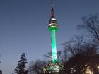 Seoul Tower at night; the color of the tower tells us about the quality of the air and how much pollution there is (green is good)