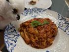 Sr. Gufo eats the pasta with the meat sauce...