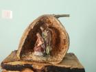This is a little Nativity set (showing Baby Jesus, Mary, and Joseph) made from a dried fig and wood!