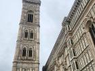 The campanile (bell tower) at Santa Maria del Fiore in Florence, in the small diamond shaped pieces near the bottom, there are symbols of different types of art and music