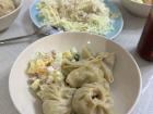 Here's our steamed buuz, the bowl has Russian salad and the blue plate has cabbage salad!