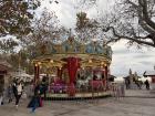 Kids ride on a carousel for the holiday season