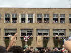 A gathering at the town hall, where members of the local "ayuntamiento" (town council) celebrate from the windows