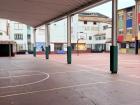 The outdoor courtyard used for recreos (breaks) and physical education
